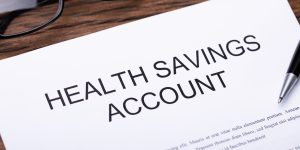 Health Savings Account Document And Pen On Table